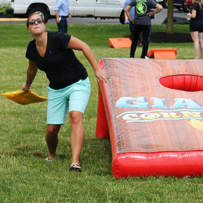 person playing giant cornhole