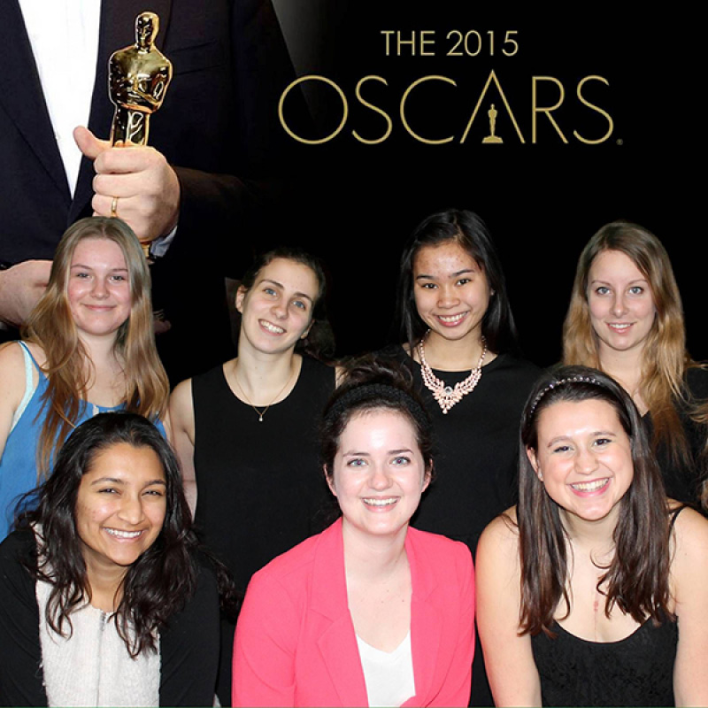 people at a photobooth with oscar awards backdrop