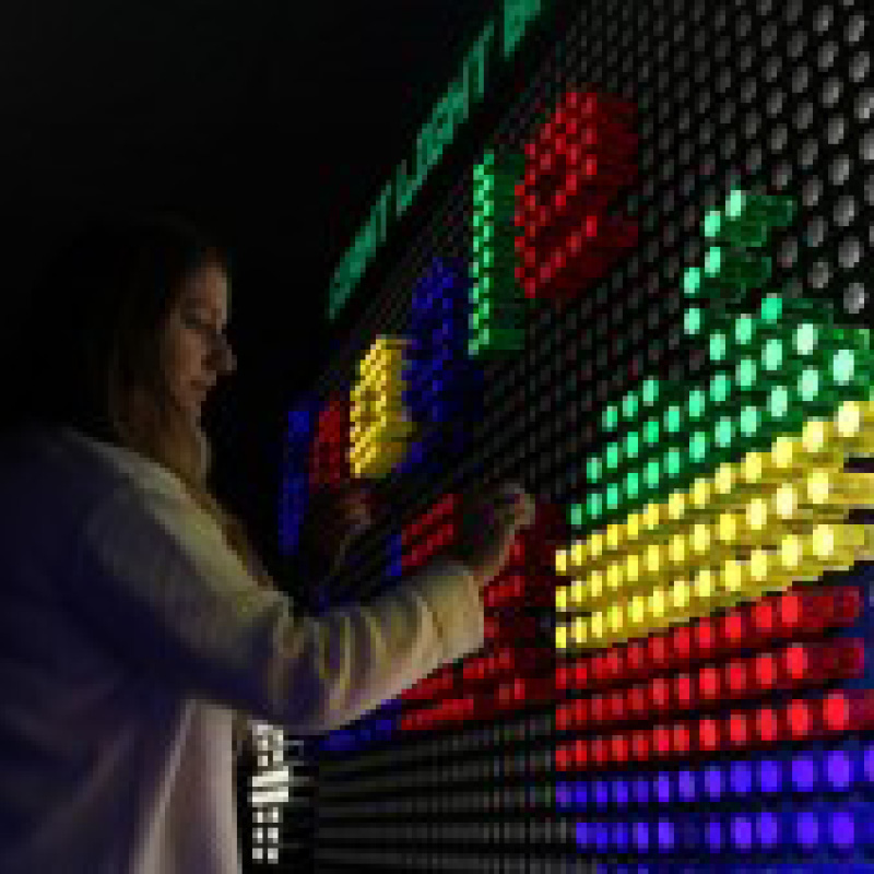 woman playing with giant light brite