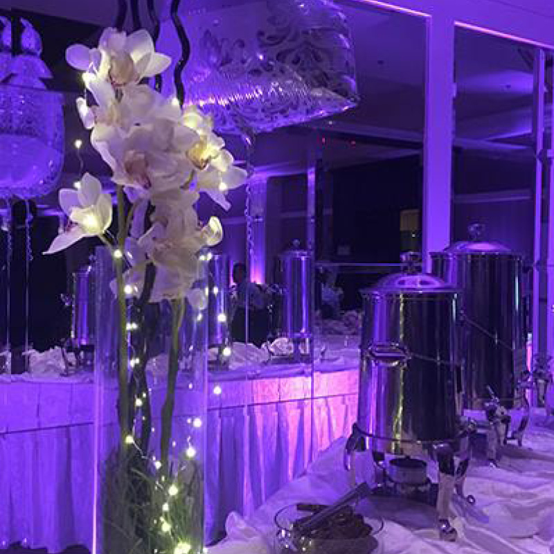 wedding reception setup with purple uplighting