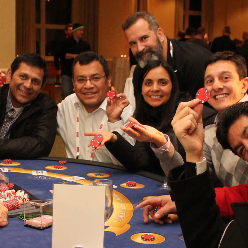 people at a casino table holding poker chips