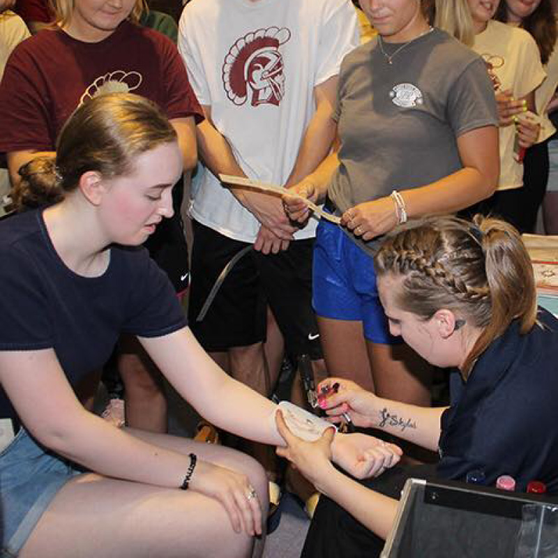 woman receiving an airbrush tattoo