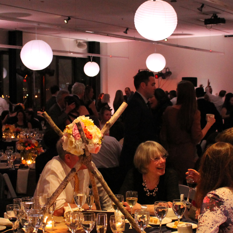 people sitting at a table enjoying an event