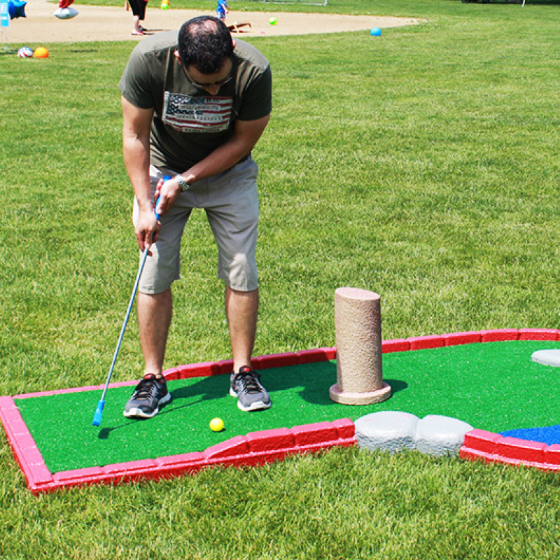 man playing outdoor mini golf