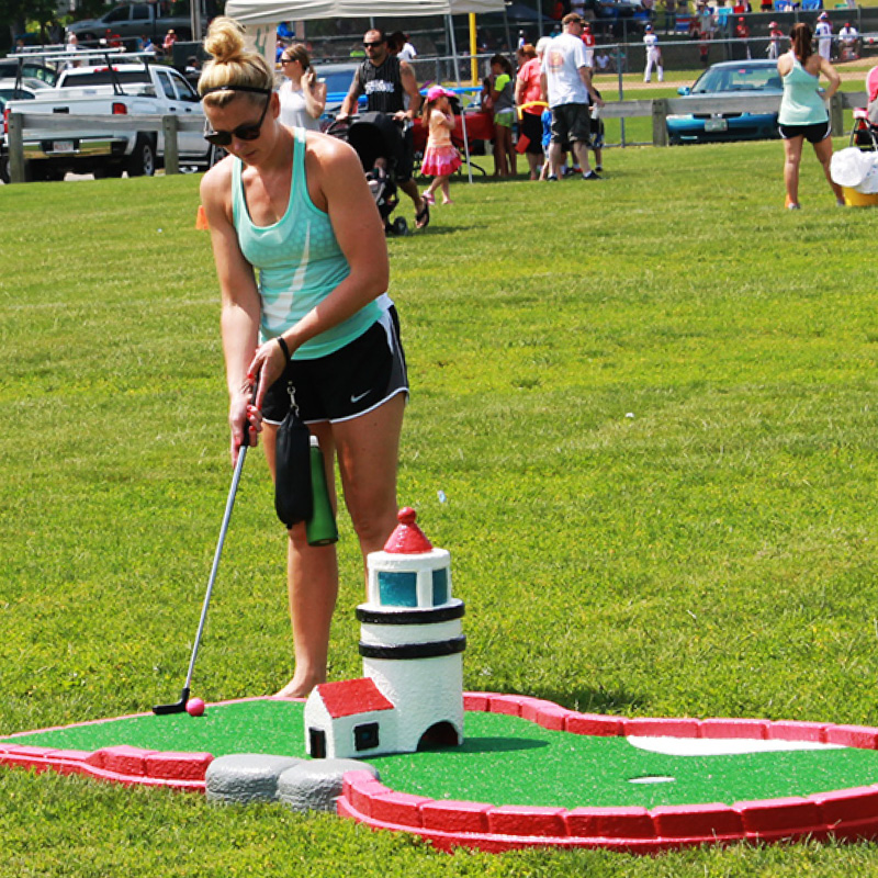 woman playing outdoor mini golf