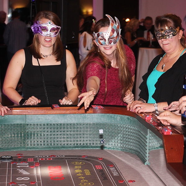 woman in masquerade mask playing craps