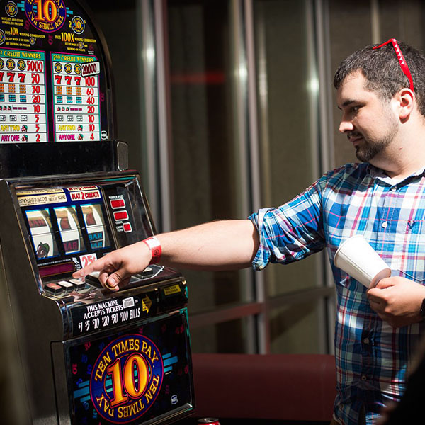 man playing slot machine